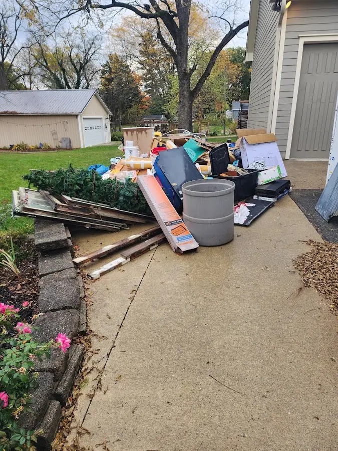 Dumpster being loaded with debris for 12 Yard Dumpster Rental in St. Paul